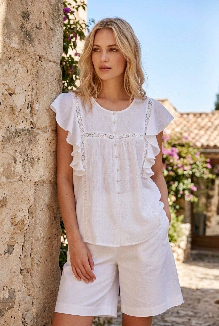Women's white blouse with ruffles and openwork embroidery