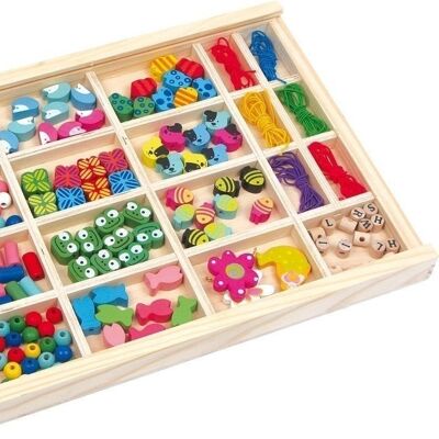 Threading beads in a wooden box