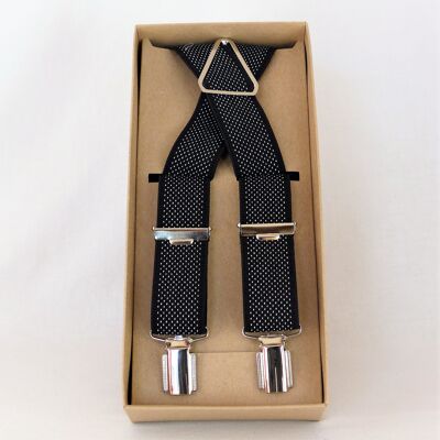 Cinturino elastico nero con puntini bianchi.