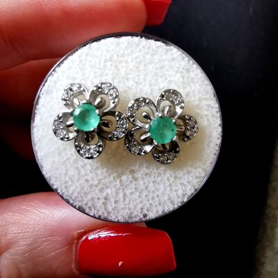 Emeralds and silver earrings.