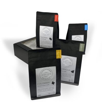 Geschenkbox mit 4x250 g frisch geröstetem Kaffee. Mittel geröstete Kaffeebohnen aus Kolumbien und Ruanda. Hell geröstete Kaffeebohnen aus Tansania & Nicaragua. Ganze Bohnen