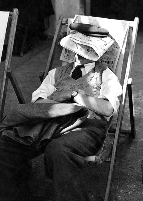 Man asleep under newspaper blank greetings card