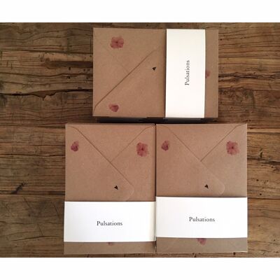 Seven recycled paper envelopes printed with rose petals