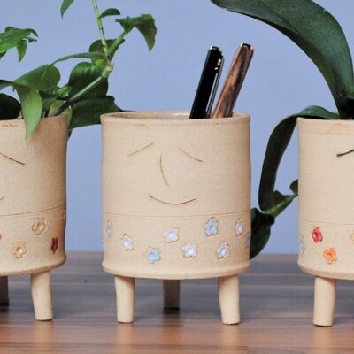 Smiley Face Planter With Legs And Blue White Flowers