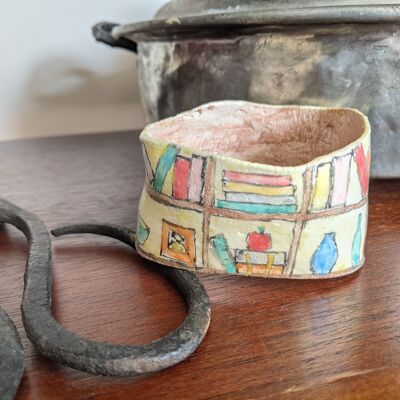 Clay bangle bracelet featuring a hand painted bookcase scene