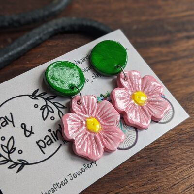 Pendientes coloridos de verano con flores rosas y tachuelas verdes