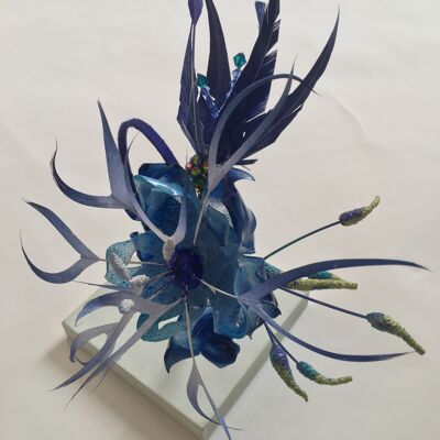 Sapphire blue feather and recycled plastic flowers on a blue silk covered band.