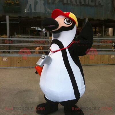 Black and white penguin REDBROKOLY mascot with a cap