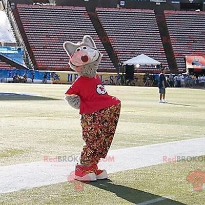 Gray wolf REDBROKOLY mascot with floral pants and a red t-shirt