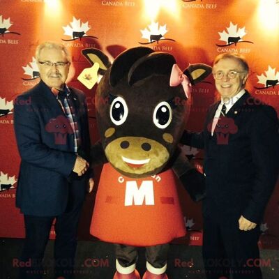 Brown cow REDBROKOLY mascot in red dress