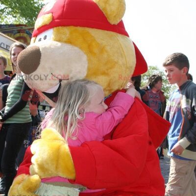 Big yellow and red bear REDBROKOLY mascot with a cap