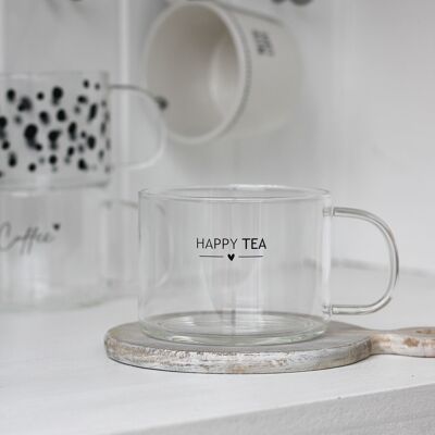Taza de cristal de té feliz