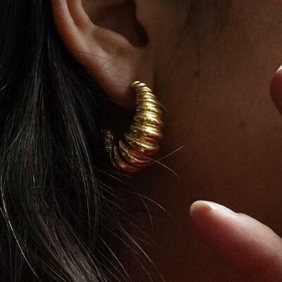 Large grooved golden steel hoop earrings