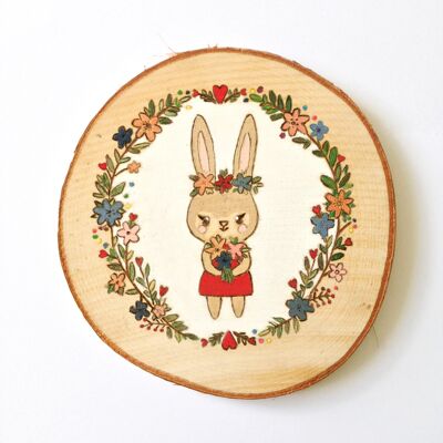 Bunny wreath of flowers on a wooden slice