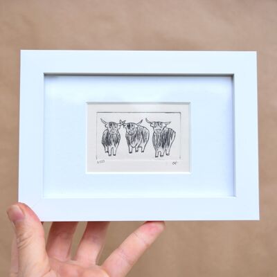Three highland cows - collagraph print in a white frame