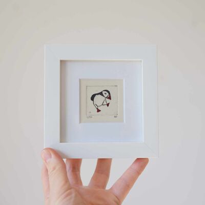 Dancing puffin, facing right - mini collagraph print in a white frame