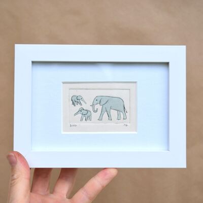 Elephant and two young (above and below) - collagraph print in a white frame