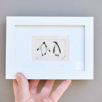 Two penguins - collagraph print in a white frame