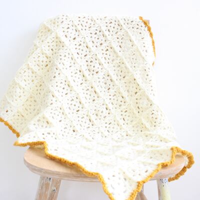 Ecru crochet baby blanket with ocher border