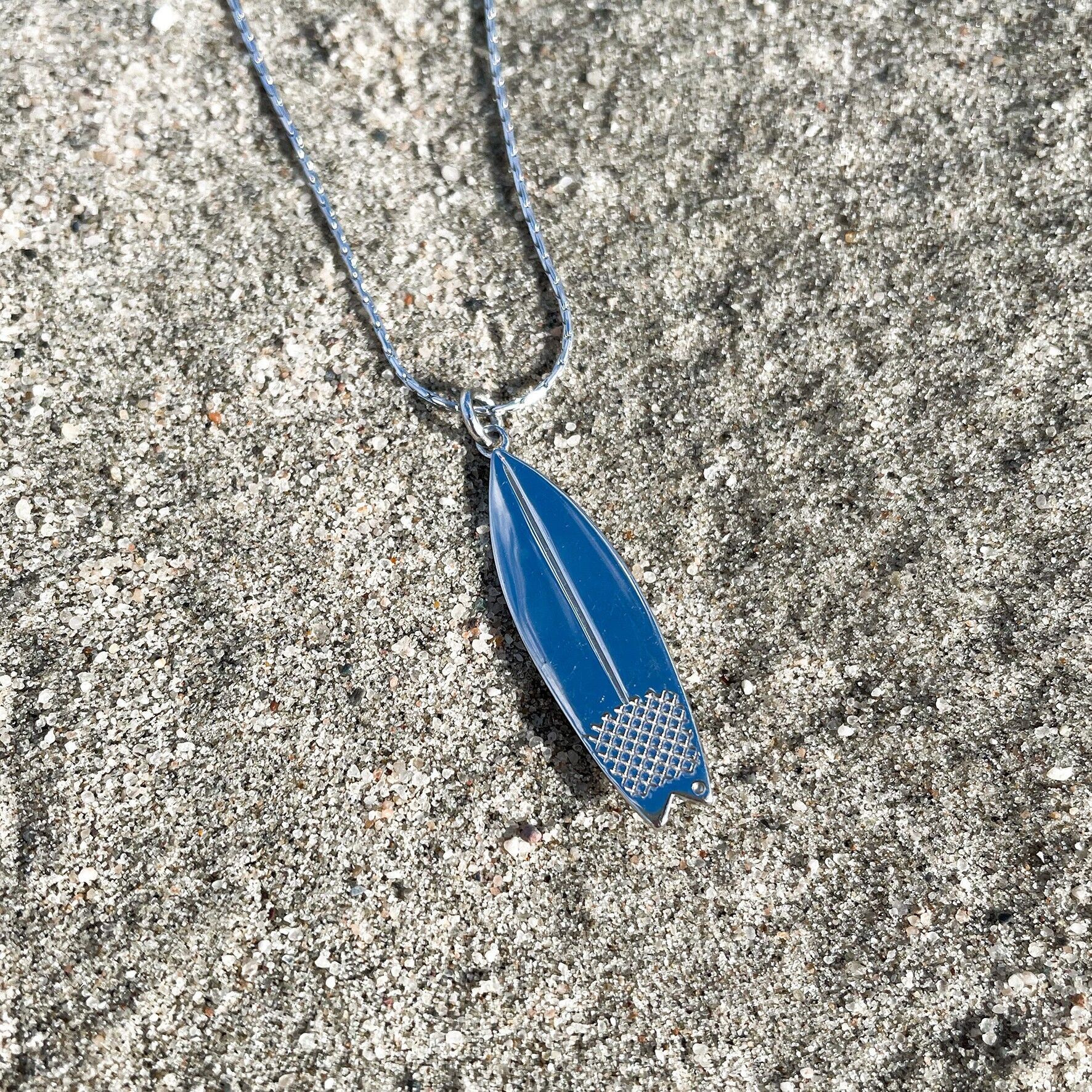 Silver surfboard store necklace