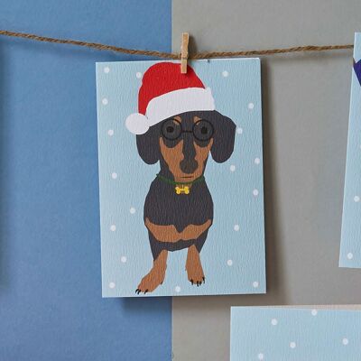 Carte de chien de saucisse de Noël portant le chapeau de santa