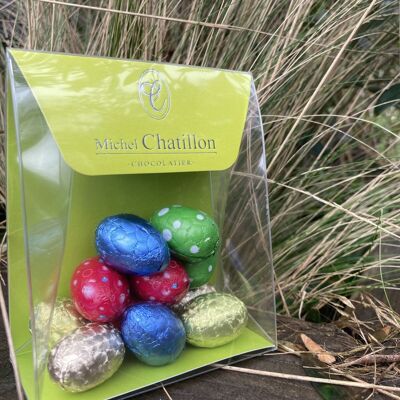 Multicolored filled Easter eggs in transparent box