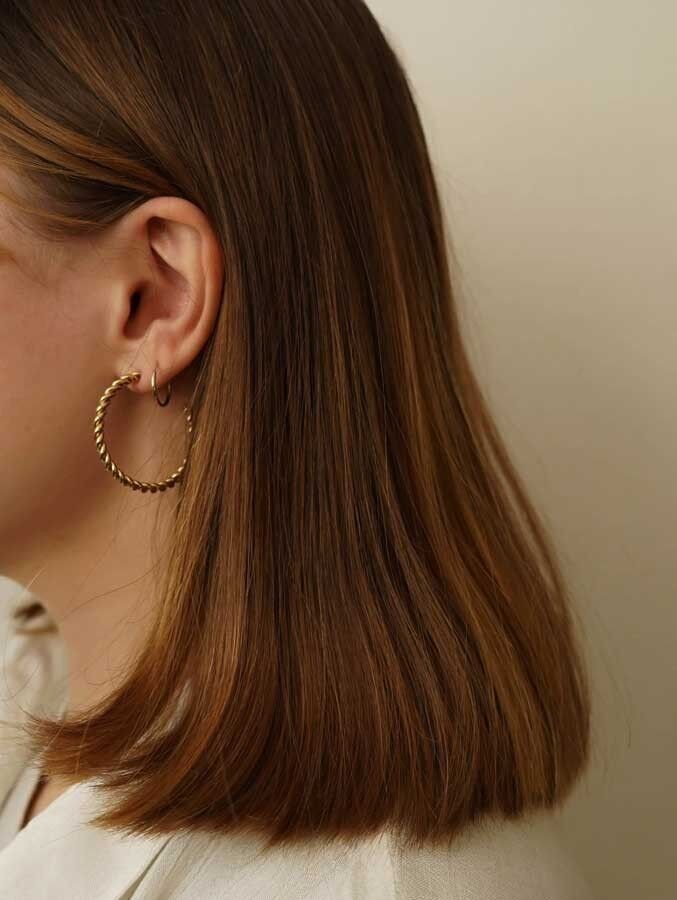 Orecchini a cerchio in acciaio a torsione aperta