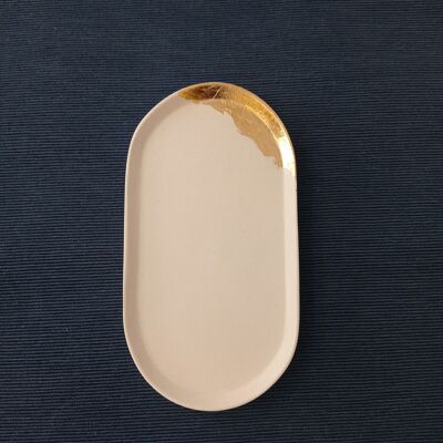 Oval white concrete tray, dotted with gold