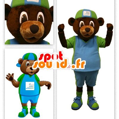 Costume de mascotte personnalisable d'ours marron en tenue verte et bleue.
