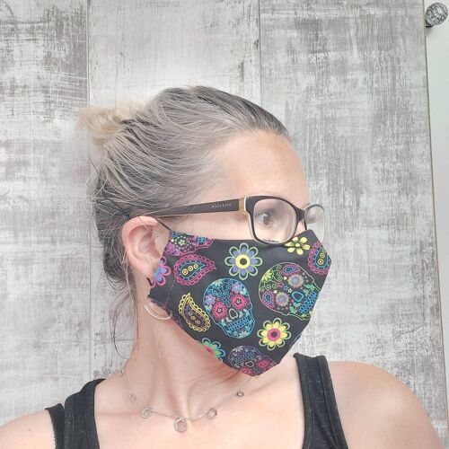Face mask with sugar skulls print.