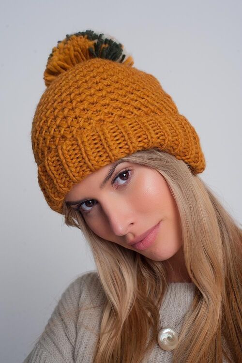 Textured knitted hat with yarn pom in mustard