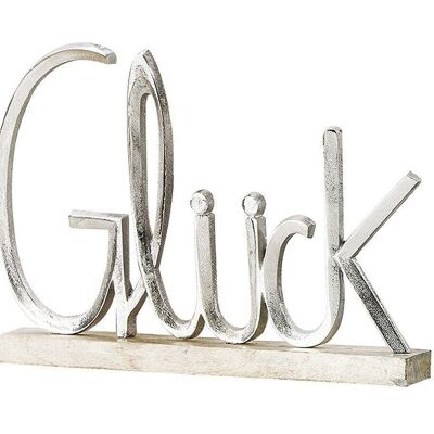 Inscription en aluminium "GLÜCK" sur socle en bois. UE 21864