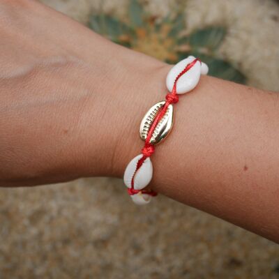 Red bracelet in natural cowrie shells and a golden cowrie