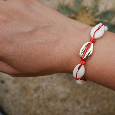 Red bracelet in natural cowrie shells and a golden cowrie