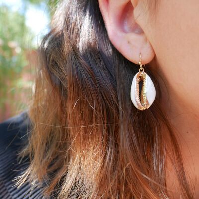 Dangling gold cowrie shell earrings