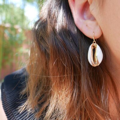 Dangling gold cowrie shell earrings