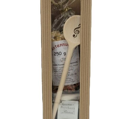 Gift set with sheet music pasta, treble clef wooden spoon and pasta sauce in carrying case