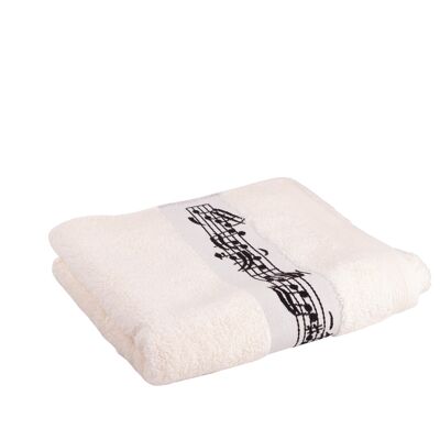 cream-colored towel with woven musical border and clef in the middle