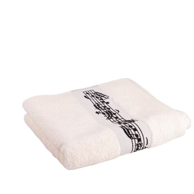 cream-colored towel with woven musical border and clef in the middle