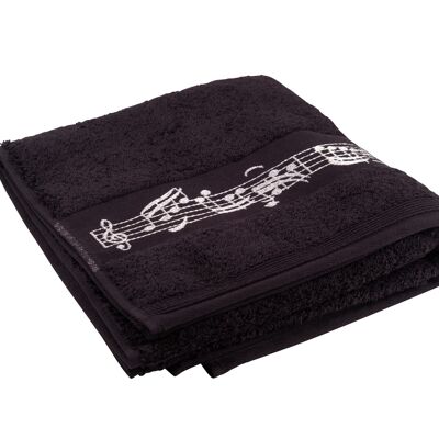 black towel with woven music border and clef in the middle