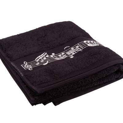 black towel with woven music border and clef in the middle