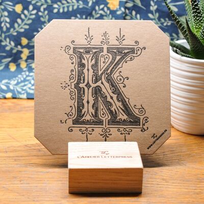 Letterpress card letter K, vintage alphabet, thick kraft recycled paper, octagon, relief, black