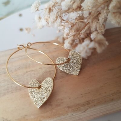 Stainless steel hoop earrings with golden heart in resinated brass