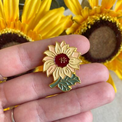 Single happy sunflower pin badge.
