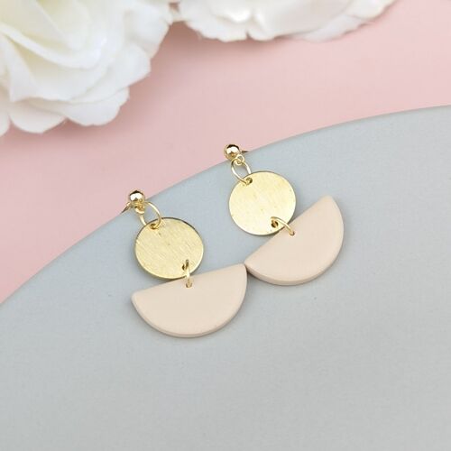 Neutral drop earrings, with brass charm.