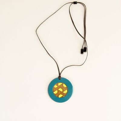 Round pendant with Ginkgo motifs with petrol green and yellow lacquer