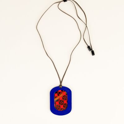 Oval pendant with geometric patterns with indigo and orange lacquer