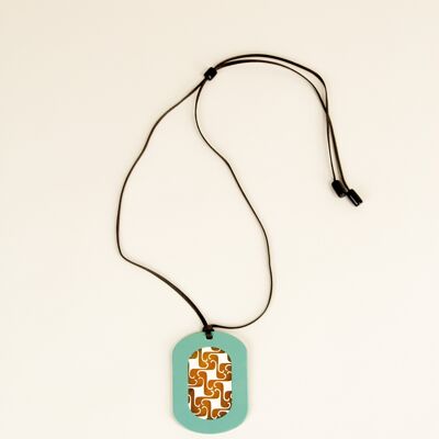 Oval pendant with geometric patterns with ivory and kakhi lacquer