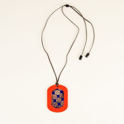 Oval pendant with geometric patterns with orange and indigo lacquer