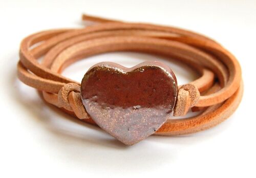 Natural leather cord with rose gold ceramic heart.